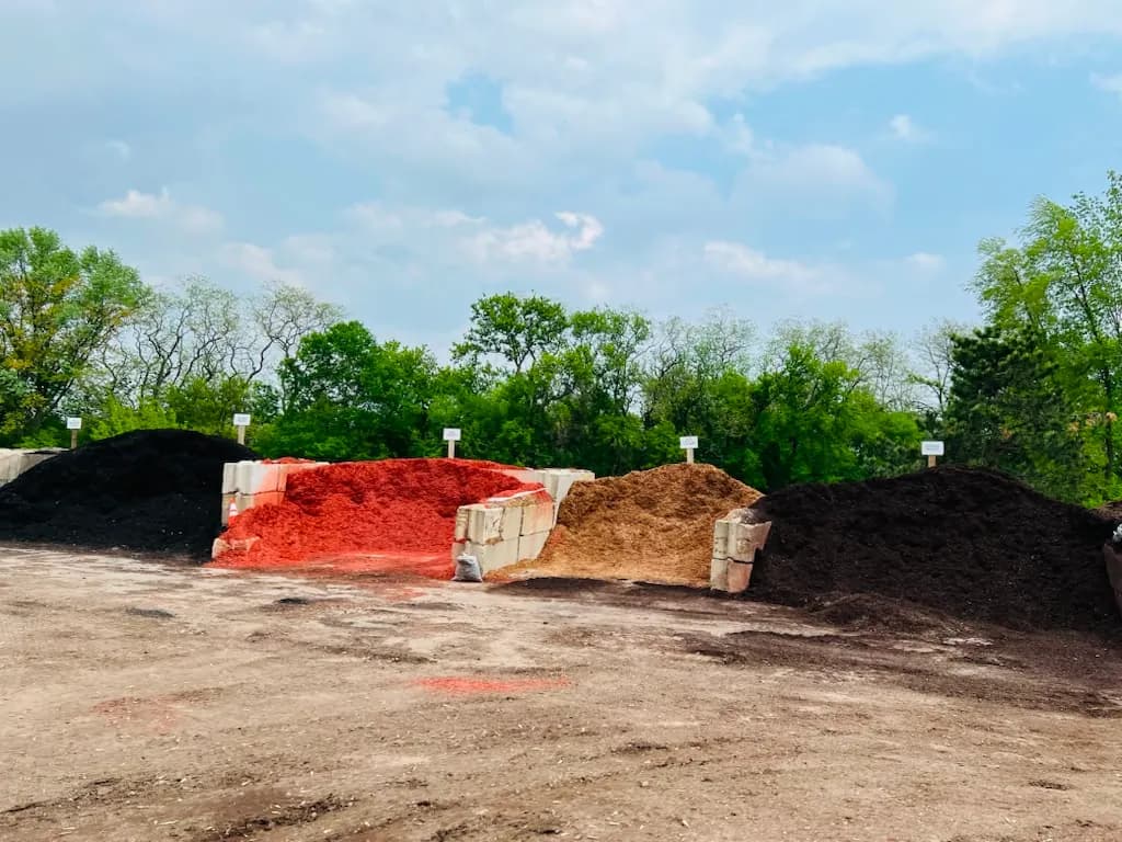 Mulch supply yard showing black brown and red mulch options
