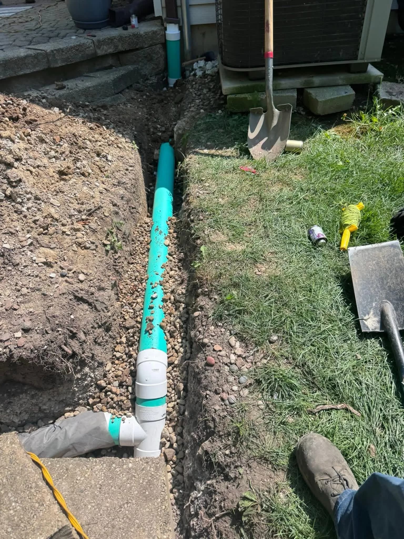 French drain installation beside a home